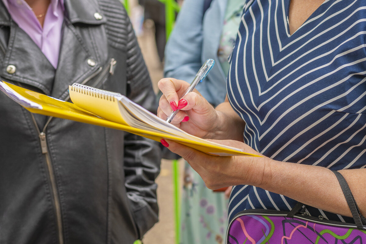 women-s-hands-are-holding-yellow-folder-with-paper-2023-11-27-05-36-09-utc-1